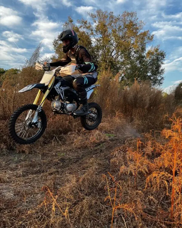 Rider crossing obstacles on his SYX Moto 125cc Dirt Bike