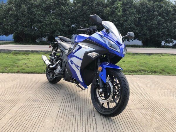 A blue and white motorcycle parked on the side of a road.