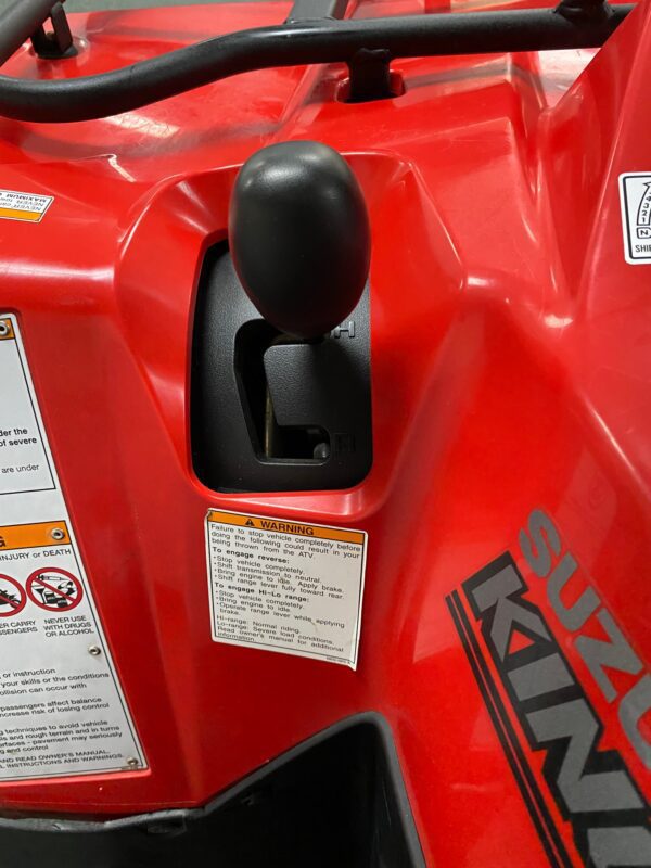 A close up of the fuel tank on a red vehicle