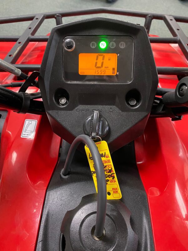 A close up of the meter on a red atv.