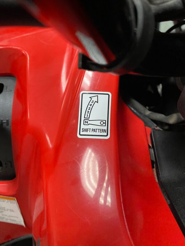 A close up of the side of a red motorcycle.