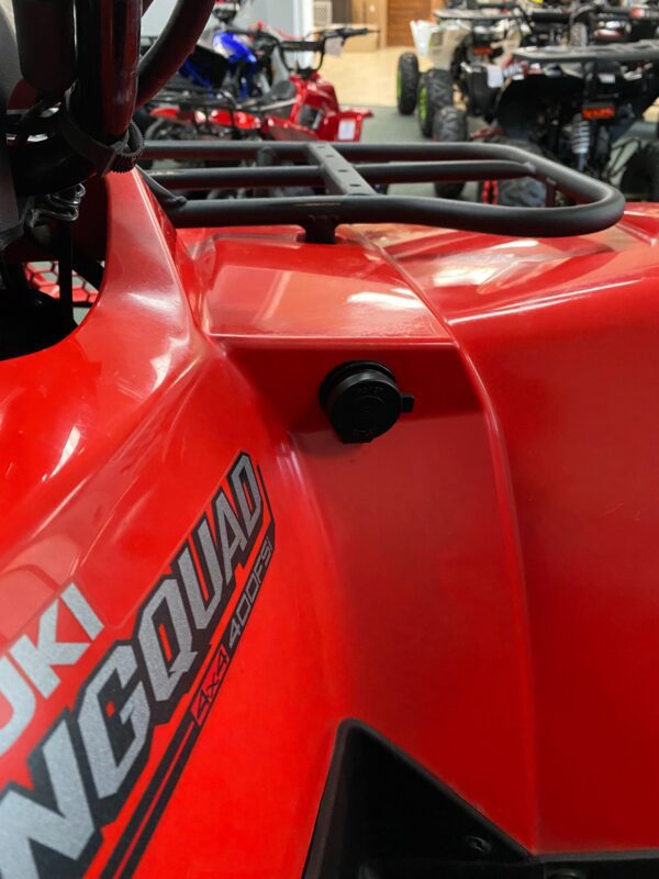 A close up of the side of a red atv.