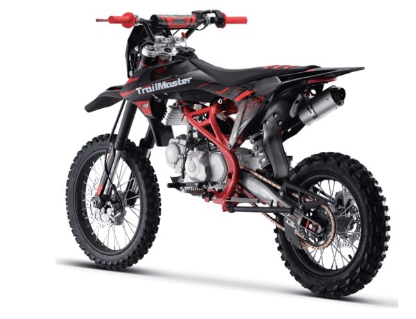 A black and red dirt bike is parked on the ground.