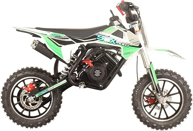 A green and black dirt bike is parked on the ground.