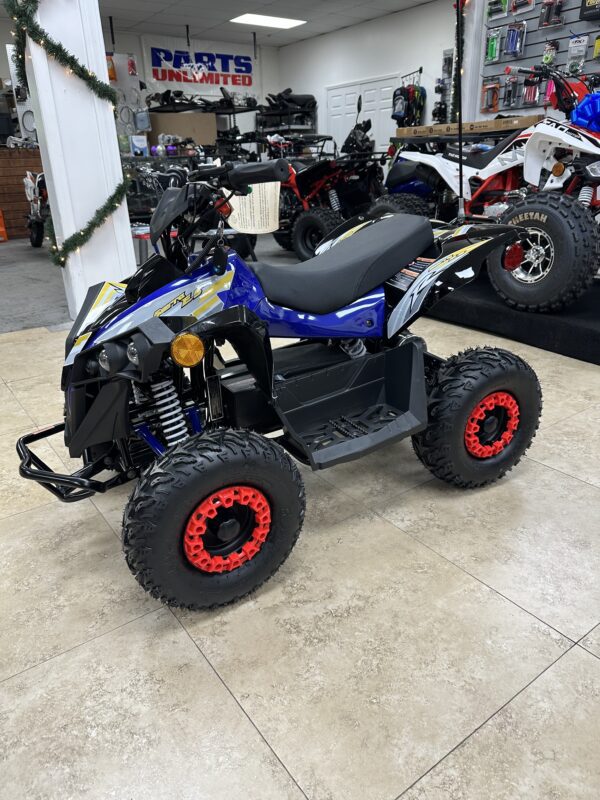 A blue and black atv is parked in a showroom.