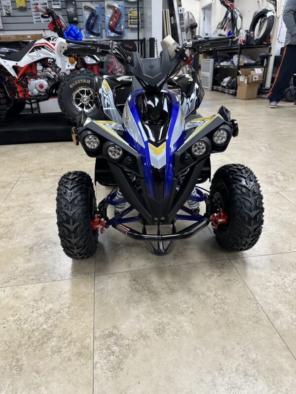 A blue and black atv parked in a showroom.