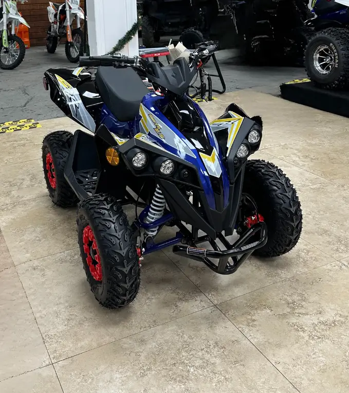 A blue and black atv parked in a garage.